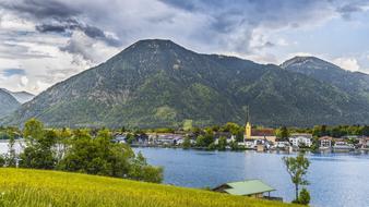 Church in town on lake shore at forested mountains, germany, Tegernsee