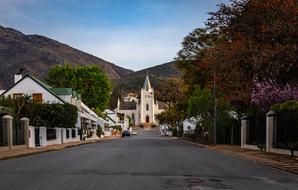 Beautiful and colorful landscape with the road, church and buildings, among the plants and mountains in Montagu, South Africa