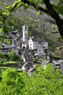 photo of stone buildings at the foot of a mountain in Ticino, Switzerland
