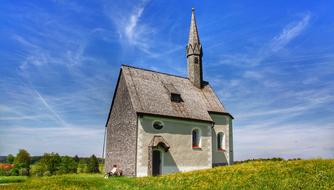 grey stone chapel in scenic rural landscape in germany, bavaria