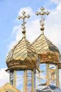 glossy metal plated tops of orthodox Church towers at sky, Ukraine