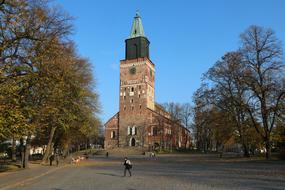 Photo of a stone church with a bell tower in Turku, Finland