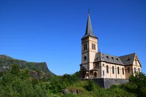 church with a spire at the top of the hill