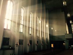 Interior of the beautiful church, with the candles and sunlight through the windows