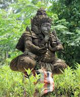 Beautiful statue of Ganesha, among the green grass and trees on Bali, Indonesia