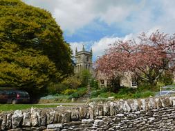Beautiful landscape with the church among the colorful plants in Cotswold, England, UK