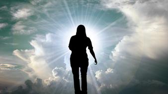 dark silhouette of a man in divine rays