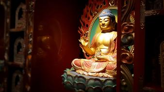 golden Buddha, ornate sculpture in temple, Singapore