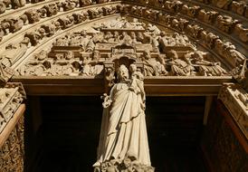 statue near the entrance to the church in paris