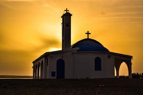 silhouette of a church in cyprus at sunset