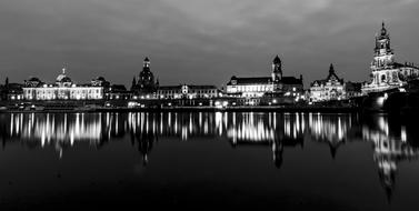 historic center of dresden is reflected in the water in black and white background