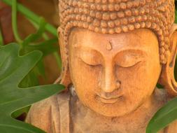 carved in wood Buddha statue in Bali