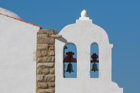 Beautiful bells, of the white Fortaleza De Sagres in Sagres, Algarve, Portugal, under the blue sky