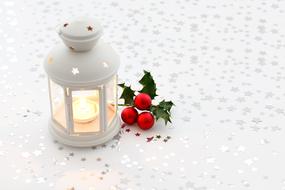 candle in a white candlestick for christmas