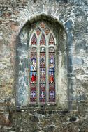 Beautiful and colorful, old, patterned stained glass window of the church