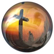 cross on a background of yellow sunset in a glass ball
