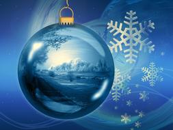 winter landscape reflected in blue christmas ball