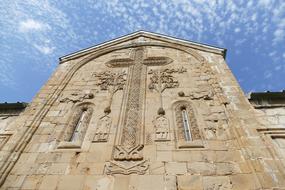 Beautiful, decorated monastery in Georgia, at blue sky with white clouds