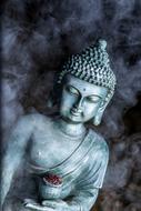 religious buddha statue in smoke
