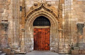wooden brown doors of the stone cathedral