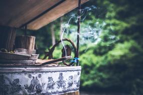 Joss stick smoking outdoor, Indonesia, Bali