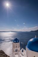 bright sun over the coast of santorini