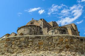 Beautiful and colorful stone church in Ayios Antonios, Cyprus, Greece, under the blue sky with white clouds