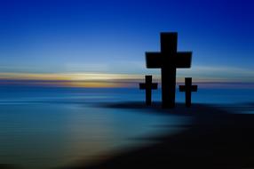 silhouettes of crosses in blue twilight