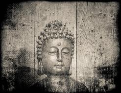 black and white image of buddha on a wooden board background