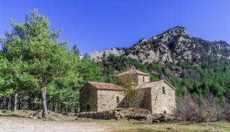 church with stone walls on the background of the mountain