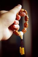 Asian rosary in hand