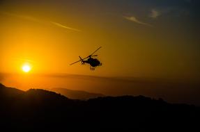 orange sun and helicopter