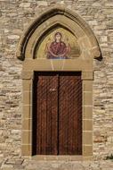 wooden door of a stone church in cyprus
