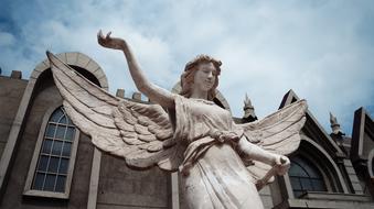 Beautiful sculpture of the angel near the building