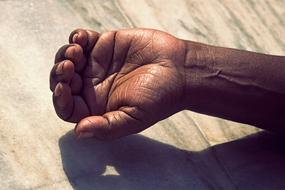 hand of brown skin person with half open palm close up