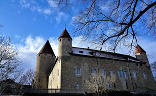 castle with towers against the sky with clouds