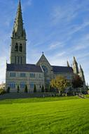 green lawn in front of a gothic cathedral in ireland