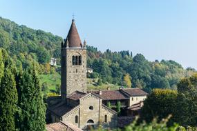 Beautiful architecture in Bergamo, Italy, among the colorful plants, at blue sky on background