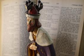 religious figure on open bible background