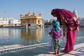 family in view of golden temple, India, Amritsar