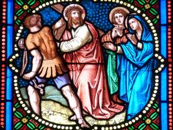 Beautiful and colorful stained glass window with people of the church