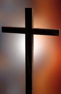 wooden cross on an orange-gray background