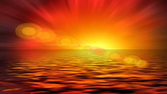 Beautiful and colorful shiny sunset above the water on horizon