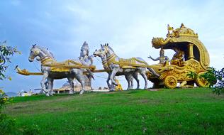 sculpture of golden carriage with horses