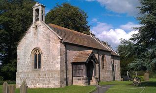 village stone church among the trees