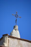 wrought iron Cross at Top of stone church