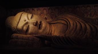 sleeping Buddha, face of stone statue