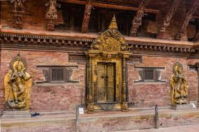 golden doors and sculptures in a building in nepal