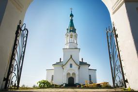 open gate to white orthodox Church