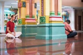 men pray in Buddhist Temple